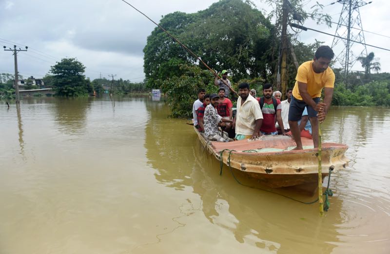 Sri Lankan residents travel by boat through the floodwaters in Pugoda, about 35 kms from capital Colombo on May 17, 2016. u00e2u20acu2022 AFP pic