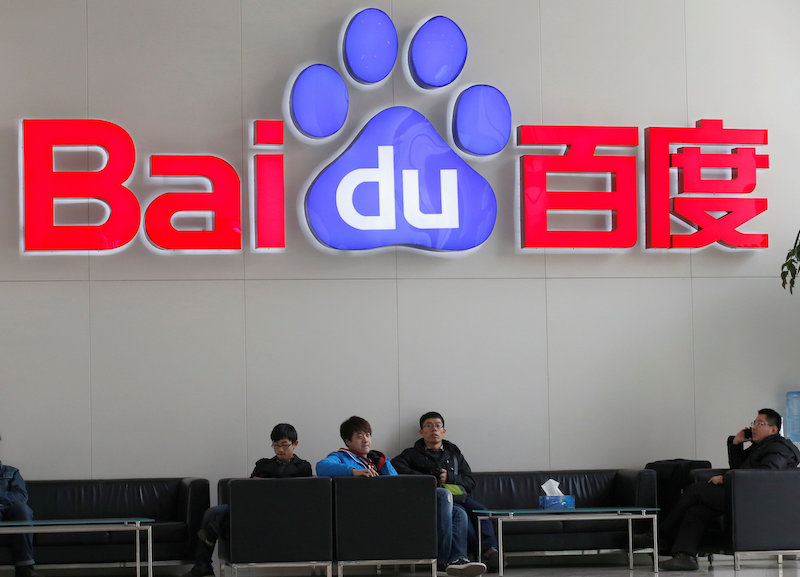 People sit in front of the company logo of Baidu at its headquarters in Beijing December 17, 2014. u00e2u20acu201d Reuters pic