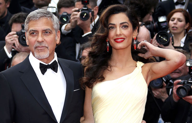 Cast member George Clooney and his wife Amal pose on the red carpet as they arrive for the screening of the film u00e2u20acu02dcMoney Monsteru00e2u20acu2122 out of competition during the 69th Cannes Film Festival in Cannes May 12, 2016. u00e2u20acu201d Reuters pic