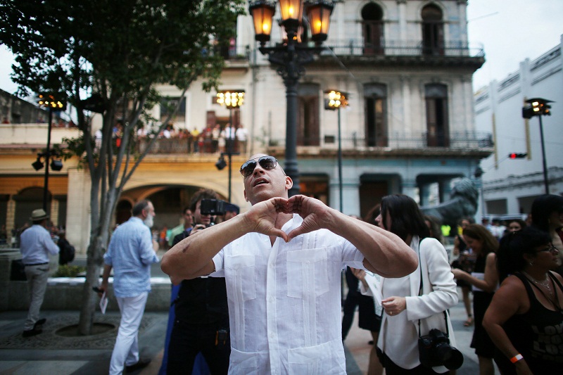 Actor Vin Diesel gestures to the public before a fashion show by German designer Karl Lagerfeld as part of his latest inter-seasonal Cruise collection for fashion house Chanel at the Paseo del Prado street in Havana, Cuba, May 3, 2016.