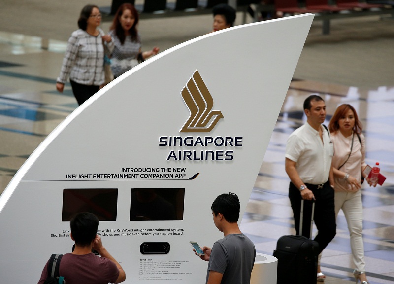 People pass a Singapore Airlines signage at Changi Airport in Singapore May 11, 2016. u00e2u20acu201d Reuters pic