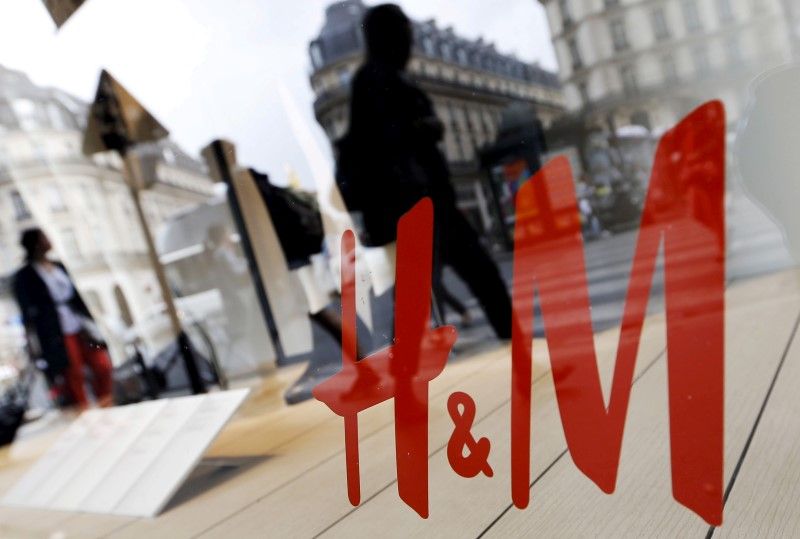 People walk past the window of a H&M store in Paris, France, May 22, 2016. u00e2u20acu201d Reuters pic