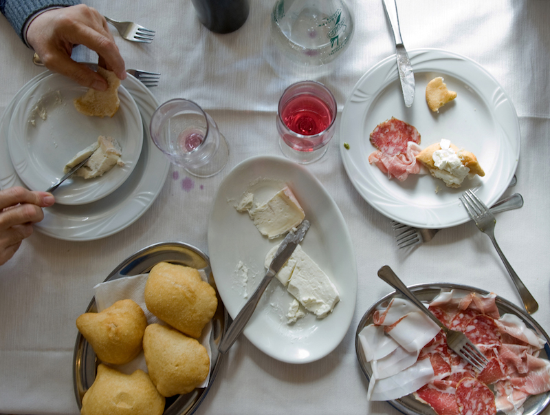 Sgabei — salty pillows of fried dough — served with prosciutto crudo and cheeses at Ristorante Emili in Fosdinovo, Italy, April 30, 2016. — Picture by Andrea Wyner/The New York Times