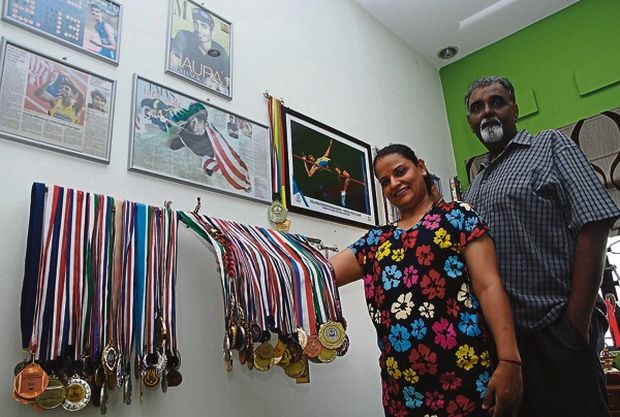 Amarjit and Manjit proudly showcase Nauraju00e2u20acu2122s medals. u00e2u20acu201d Picture by Roslan Khamis