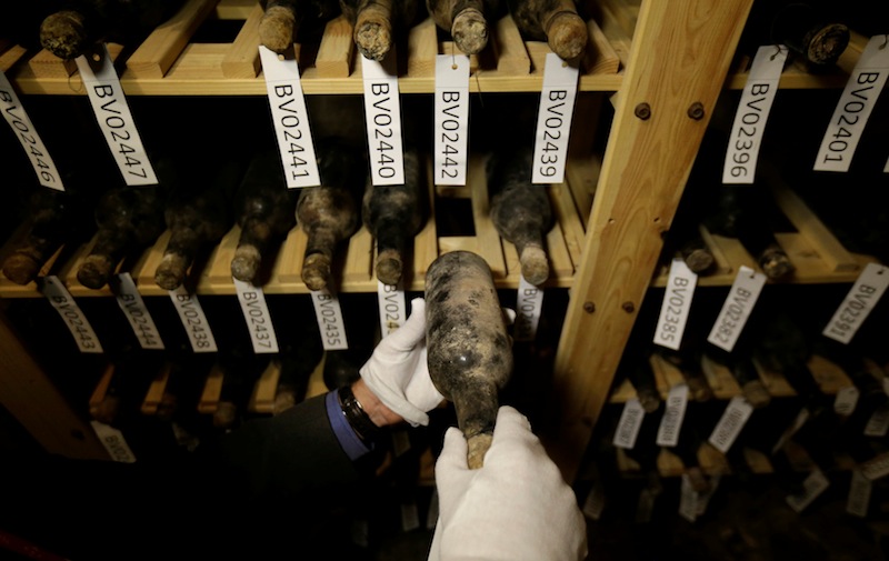 A castle manager takes a bottle of 19th-century wine out of the shelf in a cellar of Becov castle in Becov nad Teplou, Czech Republic, May 22 2016. u00e2u20acu201d Reuters pic