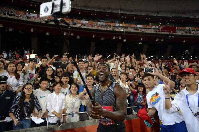 Justin Gatlin of the US (C) takes a u00e2u20acu02dcwefieu00e2u20acu2122 with fans after winning the men's 100m final at the IAAF World Challenge at the National Olympic Stadium or u00e2u20acu02dcBirds Nestu00e2u20acu2122 in Beijing May 18, 2016. WANG ZHAO / AFP 