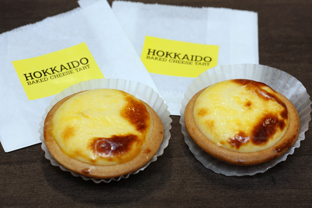 Hokkaido Baked Cheese Tart is smaller with a paler colour and biscuit-like crust