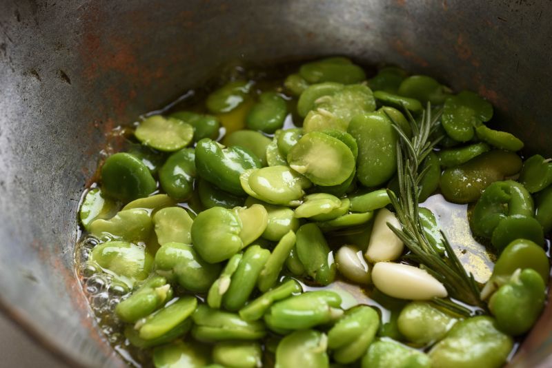 Shucked and peeled fava beans, in water on the stove with a little olive oil, garlic and chopped rosemary. u00e2u20acu2022 Picture by Karsten Moran/The New York Times