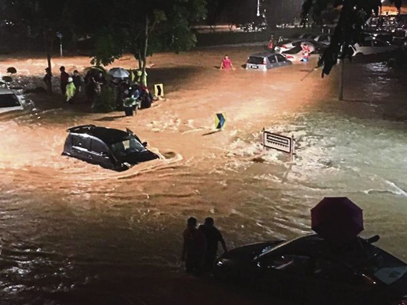A picture taken by a Universiti Malaya student that went viral on social media shows students standing on higher ground after flood waters rose on Thursday. u00e2u20acu201d file pic