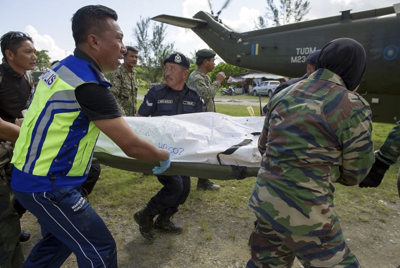 Search and rescue personnel carry the second body, which was found this morning around 1.5km from another body discovered yesterday at the banks of the Batang Lupar river. u00e2u20acu2022 Bernama pic