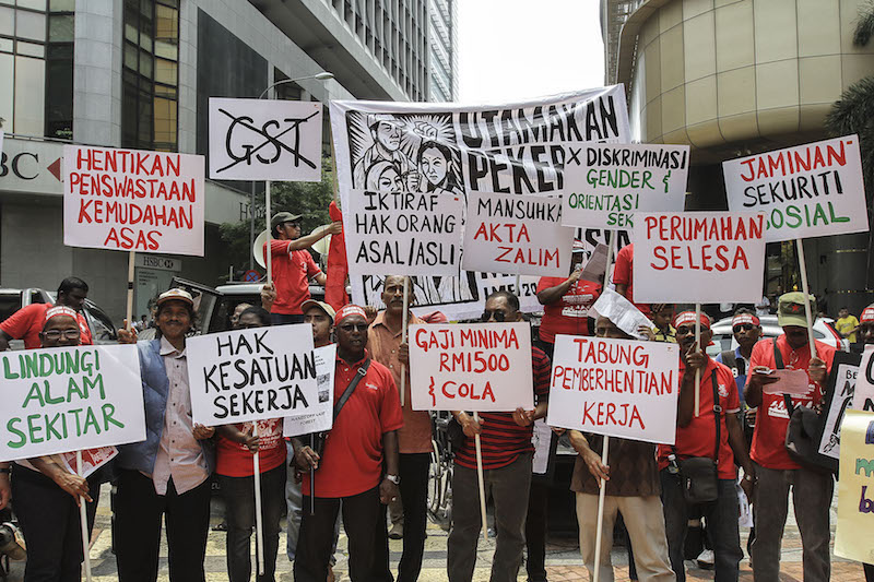 Participants hold banners during a rally held in conjunction with Labour Day in Kuala Lumpur May 1, 2016. — Picture by Yusof Mat Isa