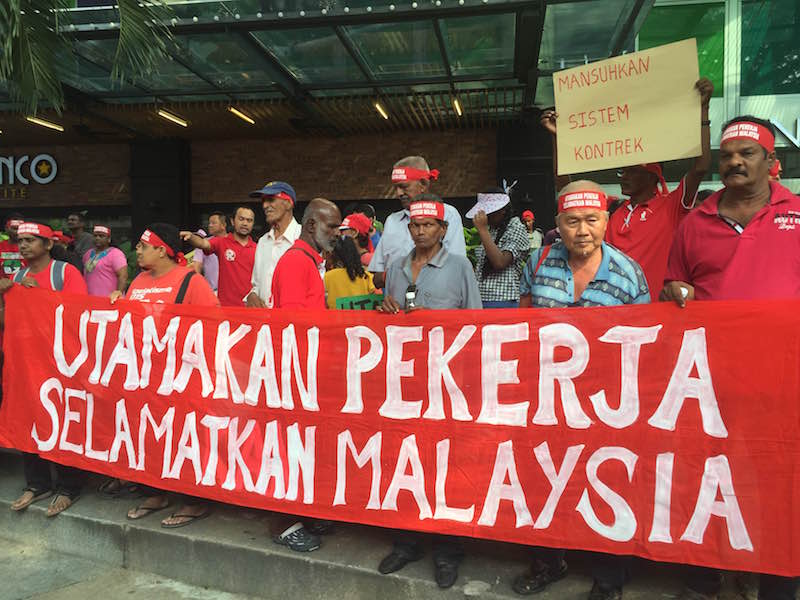 Rally participants hold a banner outside Maju Junction Mall in Kuala Lumpur May 1, 2016. u00e2u20acu201d Picture by Kamles Kumar