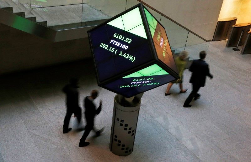 People walk through the lobby of the London Stock Exchange in London August 25, 2015. REUTERS/Suzanne Plunkett