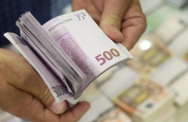 An employee of GSA Austria holds a wad of u00e2u201au00ac500 banknotes at the company's headquarters. uk.reuters.com