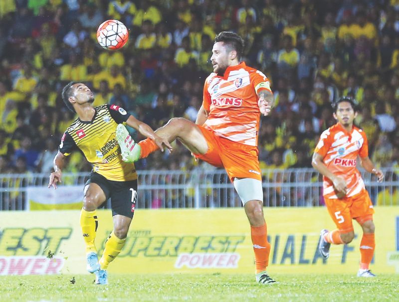 Peraku00e2u20acu2122s Mohamad Fazrul Hazli (left) and PKNS player, Gonzalo Manuel Soto challenge for the ball during their FA Cup semifinal last week. Fans have to pay more for this yearu00e2u20acu2122s final. u00e2u20acu201d Picture by Farhan Najib Yusoff