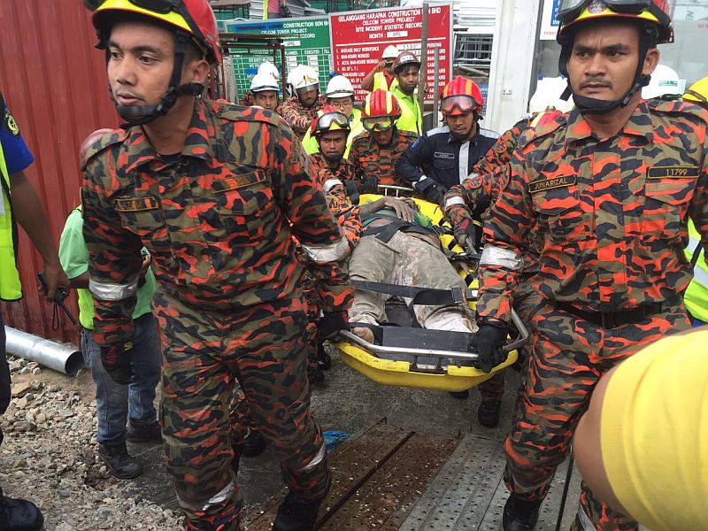 One of the workers after being rescued. The five rescued are believed to be in stable condition. u00e2u20acu201d Malay Mail pic