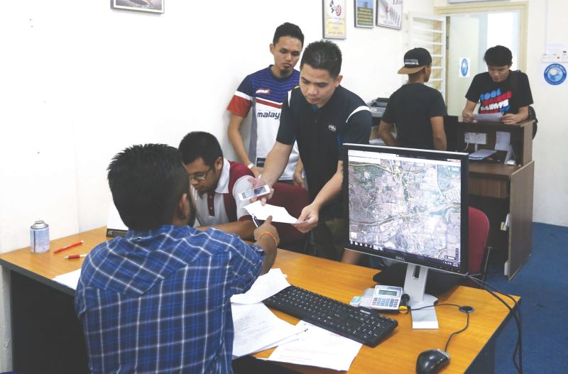 Passengers check on their refund claims at the Rayani Air headquarters in Shah Alam yesterday. u00e2u20acu201d Picture by Zuraneeza Zulkifli 