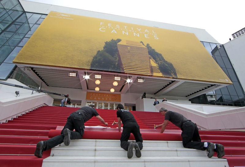 Workers install the red carpet in front of the main entrance of the Festival Palace on the eve of the opening ceremony of the 69th Cannes Film Festival in Cannes, France, May 10, 2016. u00e2u20acu201d Reuters pic