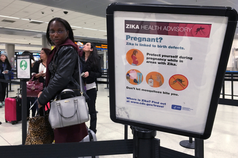 A woman looks at a Centre for Disease Control (CDC) health advisory sign about the dangers of the Zika virus as she lines up for a security screening at Miami International Airport in Miami, Florida, US, May 23, 2016. u00e2u20acu201d Reuters pic