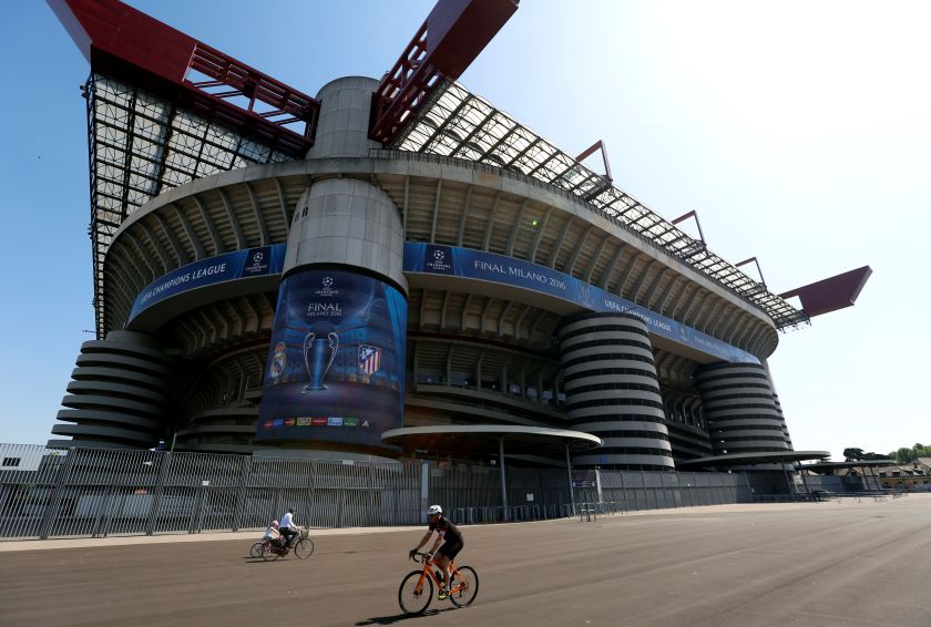 A cyclist rides in front of the San Siro stadium with the Uefa Champions League Final 2016 banners in Milan, Italy May 23, 2016. u00e2u20acu201d Reuters picnn
