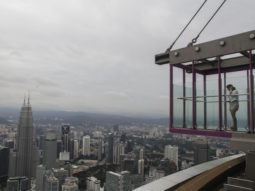 A tourist takes pictures of the Kuala Lumpur skyline at Skybox, the latest attraction at the Kuala Lumpur Tower May 24, 2016. u00e2u20acu201d Picture by Yusof Mat Isa