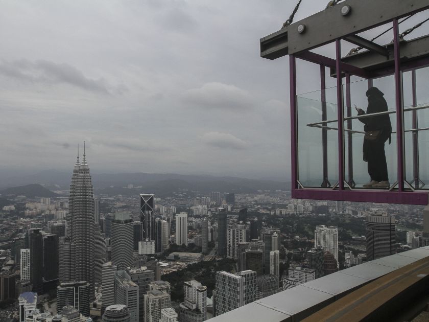 A tourist takes pictures of the Kuala Lumpur skyline at Skybox, the latest attraction at the Kuala Lumpur Tower May 24, 2016. u00e2u20acu201d Picture by Yusof Mat Isa