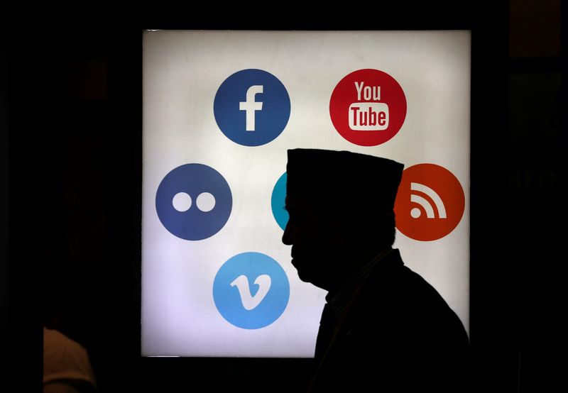 A delegate of the 41st annual meeting of the Islamic Development Bank (IDB) walks in front of social media logos at the Jakarta Convention Centre in Jakarta May 16, 2016. u00e2u20acu201d Reuters pic
