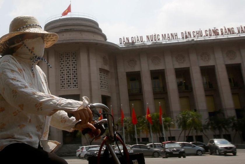 A woman rides a bicycle past the building of the State Bank of Vietnam in Hanoi May 17, 2016. u00e2u20acu2022 Reuters pic
