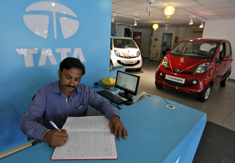 File picture shows an employee writing on a register inside the Tata Motors car showroom in Ahmedabad, India, November 6, 2015. u00e2u20acu201d Reuters pic