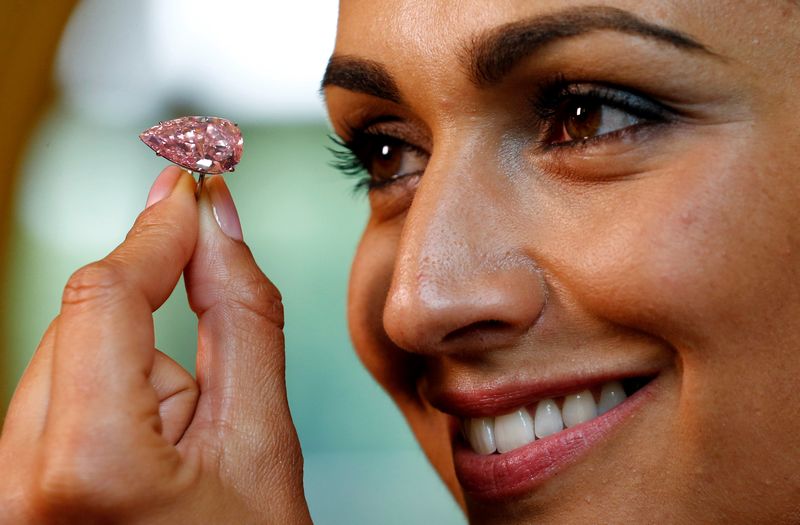 A model poses with 'The Unique Pink' diamond mounted during a preview at Sotheby's auction house in Geneva May 9, 2016. u00e2u20acu201d Reuters pic