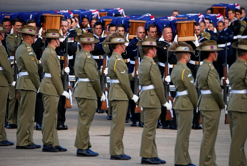 Australian Defence Force personnel carry coffins from a plane that contain the remains of 33Australian service personnel and dependents during a repatriation ceremony at the Royal Australian Air Force (RAAF) base located in Richmond, west of Sydney June 2