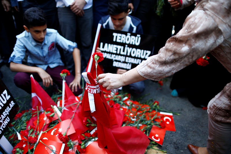 A woman places a carnation at the scene of Tuesdayu00e2u20acu2122s car bomb attack on a police bus, in Istanbul, Turkey, June 8, 2016. u00e2u20acu201d Reuters pic
