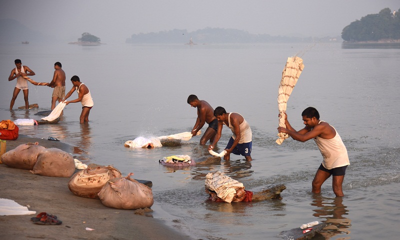 In this photograph taken on June 4, 2016, Indian dhobiwallahs or washermen do laundry on the banks of the River Bhramaputra in Guwahati. u00e2u20acu201d AFP pic