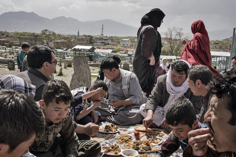 An Afghan family picnics near the graves of relatives at Kart-e-Sakhi cemetery in Kabul, Afghanistan, April 7, 2016. — Picture by Adam Ferguson/The New York Times