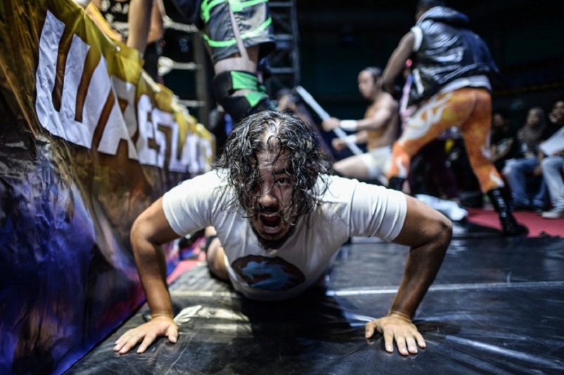 This picture taken on May 21, 2016 shows Kenneth Thexeira whose ring name is u00e2u20acu02dcThe Eurasian Dragonu00e2u20acu2122 shouting as he fights outside of the ring during the Wrestling City Asia organised by Singapore Pro Wrestling at a stadium in Kuala Lumpur. u00e2u20acu201d AFP pic
