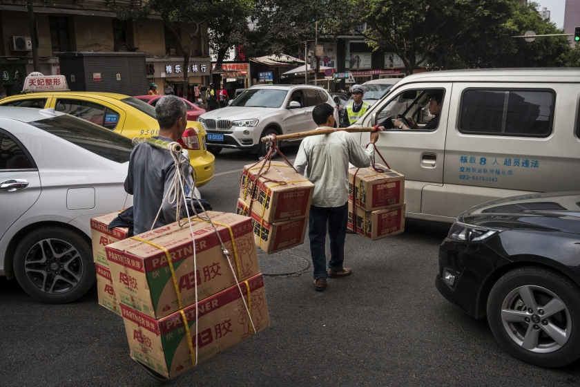 Porters, collectively known as ‘bang-bang’, carrying supplies to a passenger boat docked by the Yangtze River in Chongqing, China, April 4, 2016. — Picture by Adam Dean/The New York Times