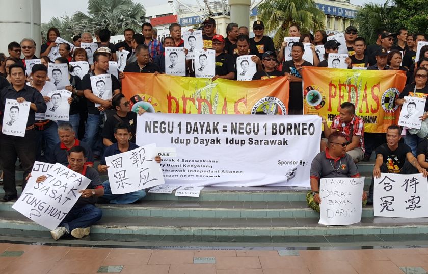 Participants holding up placards during the u00e2u20acu02dcJustice For Bill Kayongu00e2u20acu2122 assembly this morning at the Sibu Town Square , June 25, 2016. u00e2u20acu201d Picture by Sulok Tawie