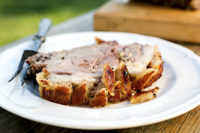 A slice of porchetta, a whole pig deboned and gutted, then stuffed with garlic and herbs, and roasted in its skin until crunchy and juicy, in New York, June 13, 2016. — Picture by Andrew Scrivani/The New York Times