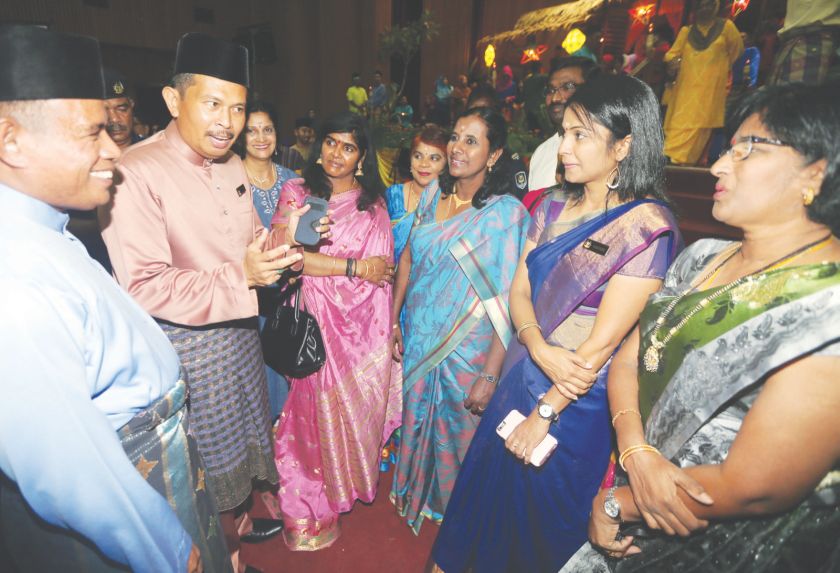Zamri (second from left) and Ipoh City Council secretary Mohd Zakuan Zakaria (left) chatting with some Indian staff dressed in sarees during the Raya gathering. u00e2u20acu201d Picture by Farhan Najib
