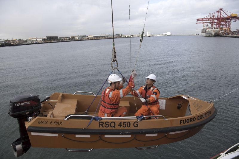 Crew lower a launch from the Fugro Equator in Fremantle, Australia, after 43 days at sea searching for the missing Malaysia Airlines Flight 370, May 5, 2016.