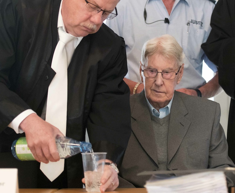 Reinhold Hanning receives a glass of water from his lawyer Andreas Scharmer in a courtroom before the continuation of his trial in Detmold, Germany, May 20, 2016. u00e2u20acu201d Reuters pic