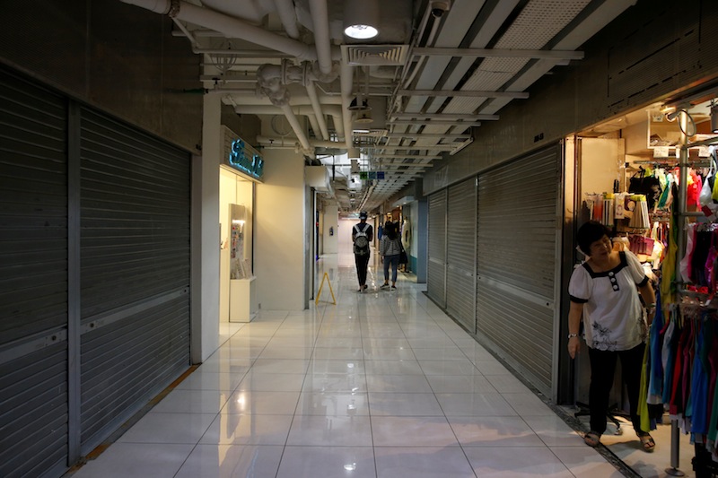 People pass closed shops at a section of a mall in Singapore May 27, 2016. u00e2u20acu201d Reuters pic