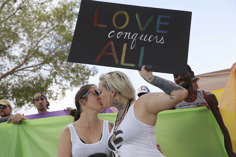 Tiffany Findley (left) and Adriana Kelley kiss outside the wake for Pulse shooting victim Javier Jorge Reyes in a counter protest against the Westboro Baptist Church in Orlando, Florida June 15, 2016. u00e2u20acu201d Reuters pic