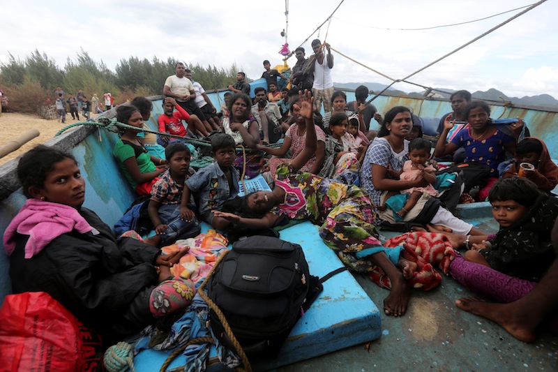 Some of more than forty Sri Lankan migrants wait on board a boat after it was beached to receive supplies and fuel off the coast of Lhoknga, near Banda Aceh in Aceh province, Indonesia June 14, 2016. u00e2u20acu201d Reuters pic