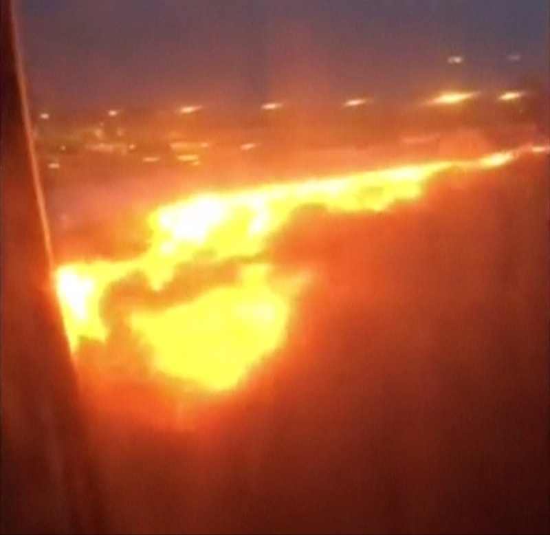 Fire burns on the right wing of a Singapore Airlines Boeing 777-300ER aircraft originally bound for Milan in this still image taken from handout video, at Changi Airport in Singapore June 27, 2016. u00e2u20acu201d Reuters pic