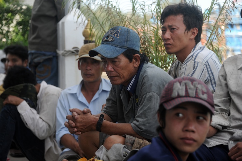 Vietnamese fishermen sit on shore after they were detained at sea by the Thai Royal Marine Police in Thailand's province of Narathiwat on February 14, 2016. u00e2u20acu201d AFP pic
