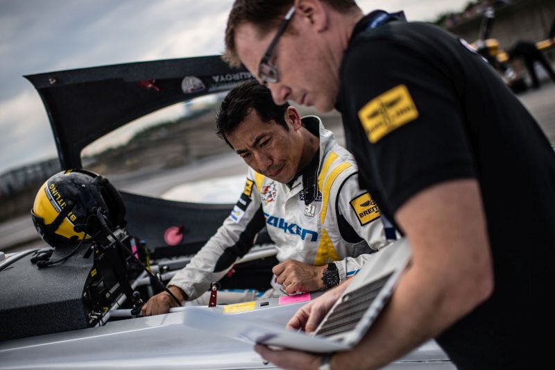 Muroya (left) prepares for his flight with his race analyst Benjamin Freelove.