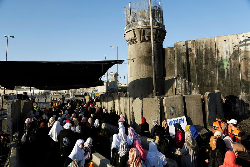 Palestinians wait to cross through Israeli Qalandia checkpoint as they make their way to attend the third Friday prayer of the holy fasting month of Ramadan in Jerusalem's al-Aqsa mosque, June 24, 2016. u00e2u20acu201d Reuters pic