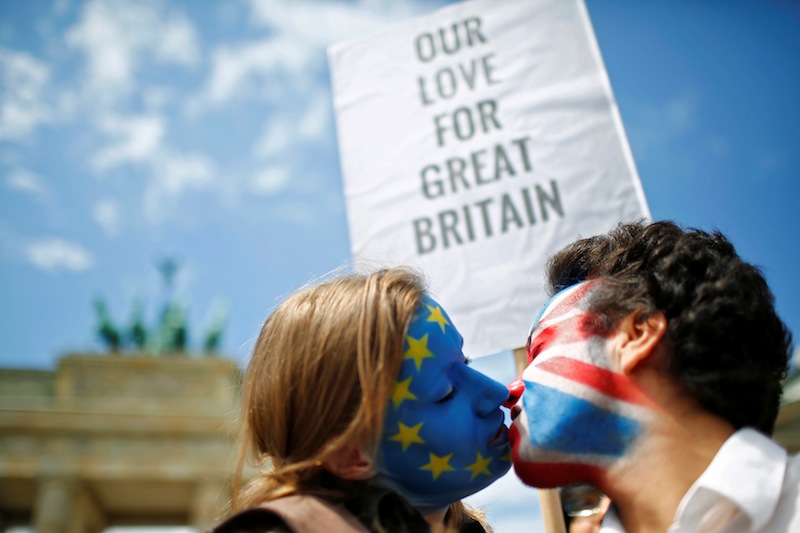 Two activists with the EU flag and Union Jack painted on their faces kiss each other in front of Brandenburg Gate in Berlin, Germany, June 19, 2016. u00e2u20acu201d Reuters pic