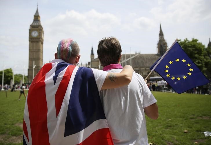 Participants with a British Union flag and an EU flag sit and look at Big Ben after attending a pro-EU referendum event at Parliament Square in London, Britain June 19, 2016. u00e2u20acu201d Reuters pic